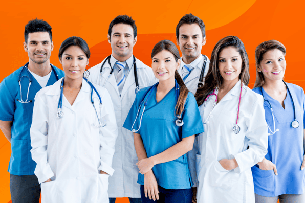A diverse group of smiling healthcare professionals, including doctors and nurses in white coats and scrubs, standing together against an orange background, symbolizing teamwork in healthcare.