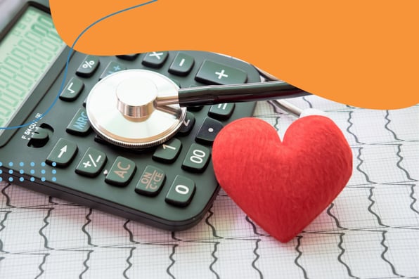 Stethoscope resting on a calculator next to a red heart-shaped object, placed over an EKG printout—symbolizing the intersection of healthcare, finance, and heart health.